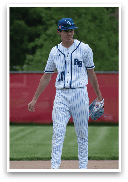 A baseball player wearing a blue and white uniform. Description generated by AI