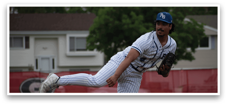 A baseball player in a blue and white uniform is pitching a ball. Description generated by AI