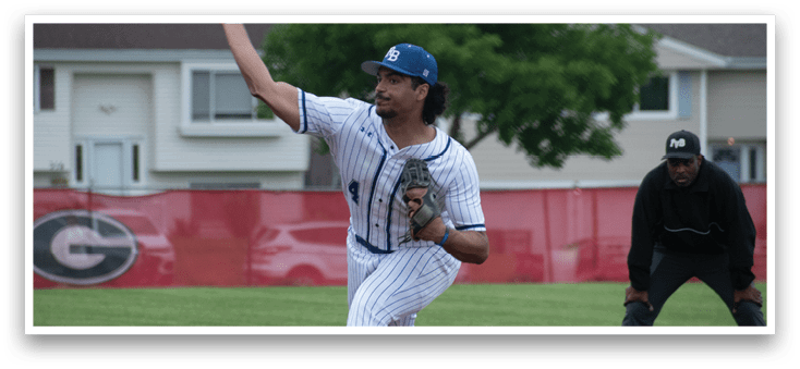 A baseball player in a blue cap and white uniform is pitching a ball. Description generated by AI