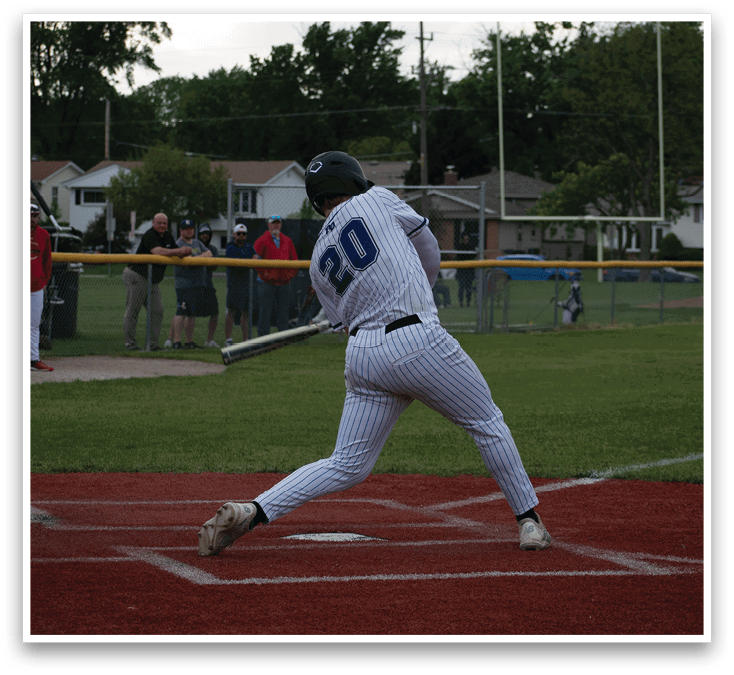 A baseball player in a blue and white uniform is swinging a bat. Description generated by AI