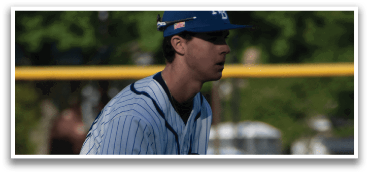 A baseball player wearing a blue and white uniform. Description generated by AI