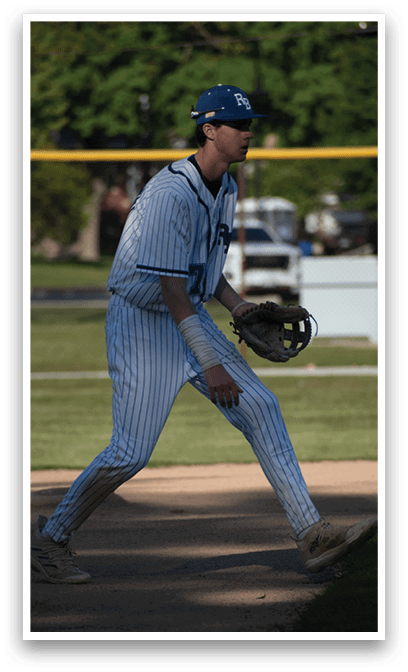 A baseball player wearing a blue and white uniform. Description generated by AI