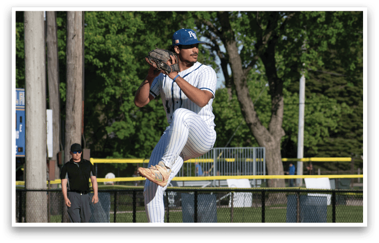 A baseball player in a white uniform is pitching a ball. Description generated by AI