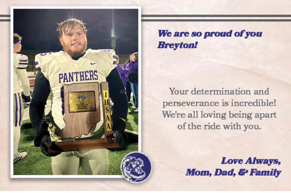 A football player holds a trophy with the words “we are so proud of you BREYTON!" written on it. AI generated content
