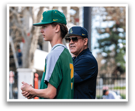 A man and a boy are standing on a baseball field. The boy is wearing a green and yellow shirt. AI generated content