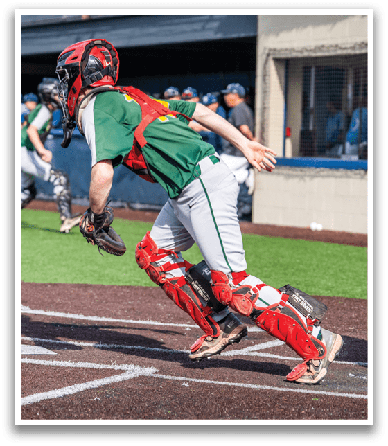 A baseball player in a green jersey is running towards home plate, while a catcher in red pads is trying to catch the ball. AI generated content