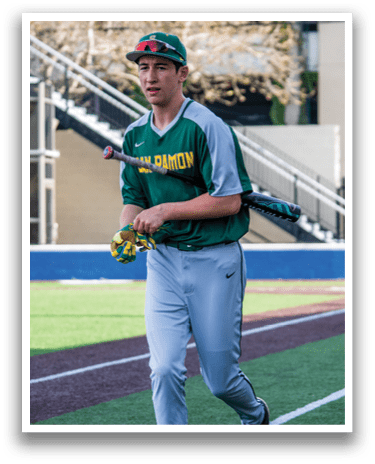 A baseball player wearing a green and gray uniform is walking on the field while holding a bat. AI generated content