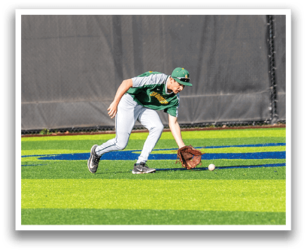 A baseball player in a green and grey uniform is bending over to pick up a baseball. AI generated content