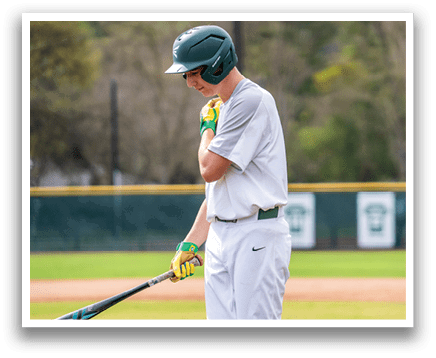A baseball player in a green helmet and white uniform holding a bat. AI generated content