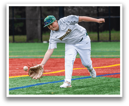 A baseball player in a white uniform is reaching for a ball on the field. AI generated content
