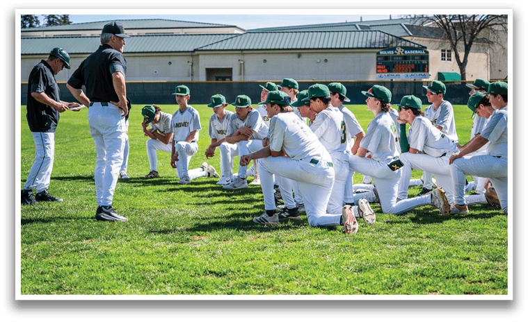A group of baseball players are sitting on the grass, listening to their coach. AI generated content