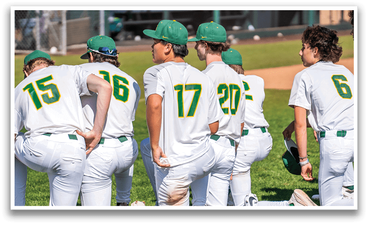 Baseball players wearing green and yellow hats and white uniforms kneeling on the grass. AI generated content