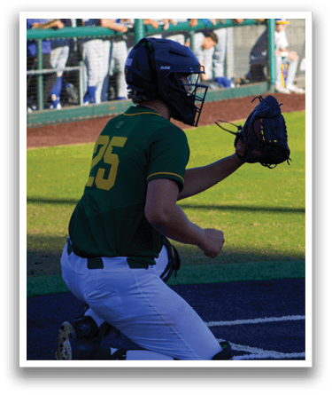 A baseball player wearing a green and yellow jersey is bending over to catch a ball. AI generated content