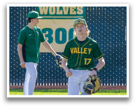A baseball player wearing a green and yellow jersey stands on a field with his glove on. AI generated content
