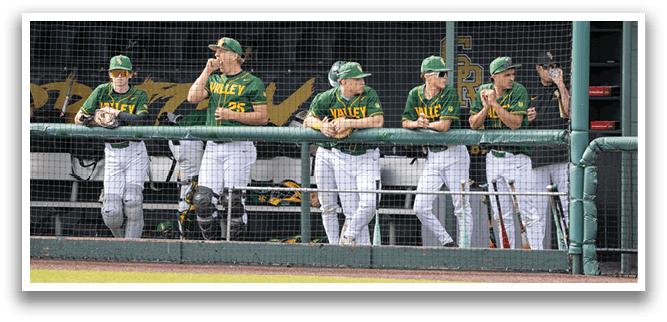 Baseball players in green and yellow uniforms are sitting on a bench. AI generated content