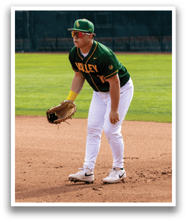 A baseball player in a green and yellow uniform is standing on the field, holding a catcher's mitt. AI generated content