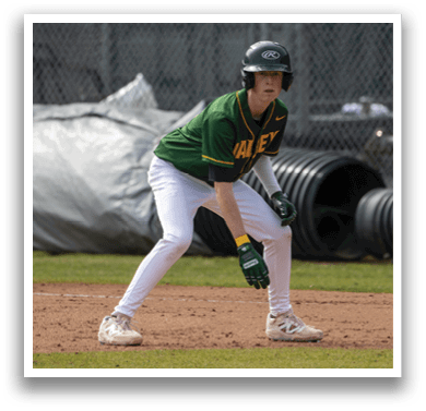 A baseball player in a green and white uniform is standing on the field, wearing a helmet and holding a baseball bat. AI generated content