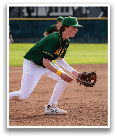 A baseball player wearing a green and yellow uniform is crouching on the field, holding a baseball glove. AI generated content
