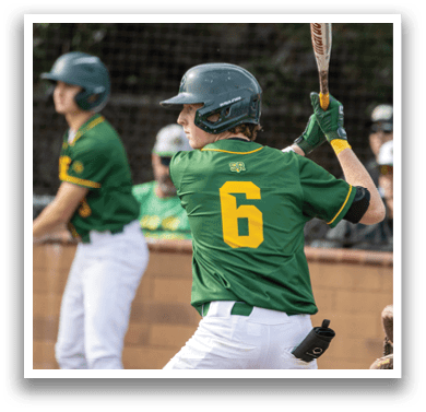 A baseball player in a green and yellow uniform is swinging a bat, preparing to hit the ball. AI generated content