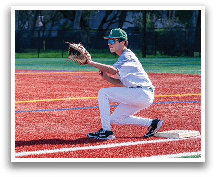 A young man in a baseball uniform is kneeling on the ground, wearing a catcher's mitt and preparing to catch a ball. AI generated content