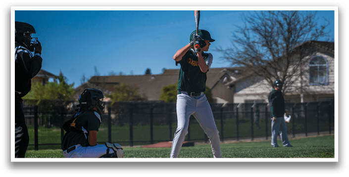 A baseball player in a green and white uniform is swinging a bat at a ball. AI generated content