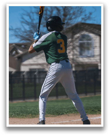 A baseball player in a green and yellow uniform is swinging a bat on a field. AI generated content