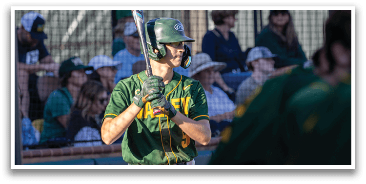 A baseball player holding a bat. Description generated by AI
