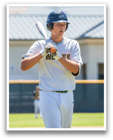 A baseball player wearing a grey shirt and white pants holding a bat. Description generated by AI