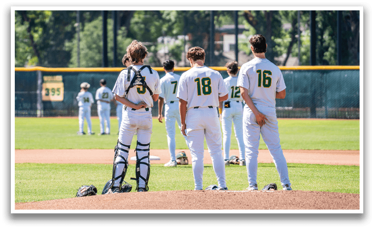 A group of baseball players standing on a field. Description generated by AI
