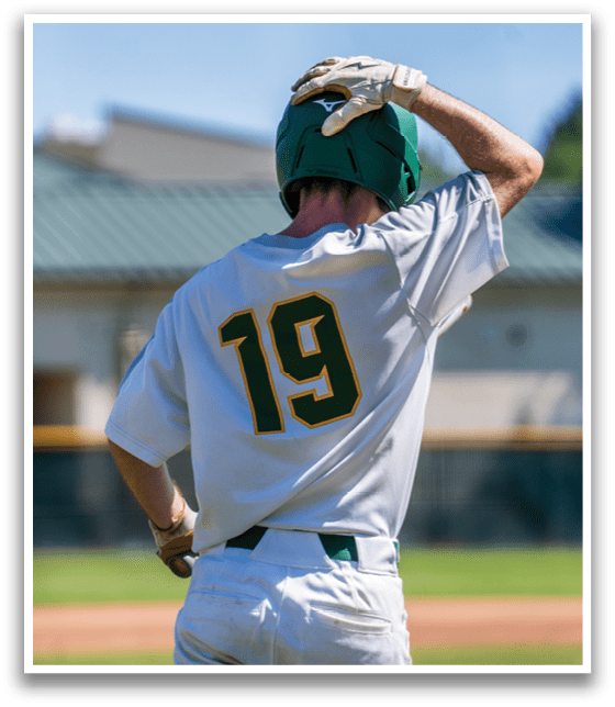 A baseball player wearing a white and green jersey with the number 19 on the back. Description generated by AI