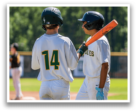 Two baseball players wearing white uniforms and helmets. Description generated by AI