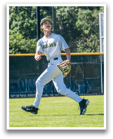 A boy wearing a baseball uniform is running on a field. Description generated by AI