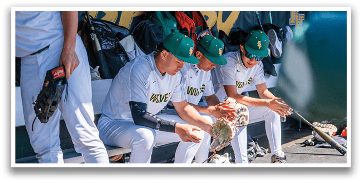 A group of baseball players sitting on a bench. Description generated by AI