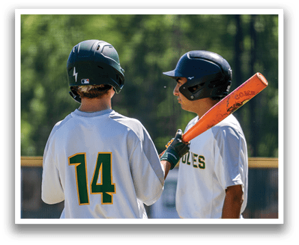 Two baseball players wearing white uniforms and helmets. Description generated by AI