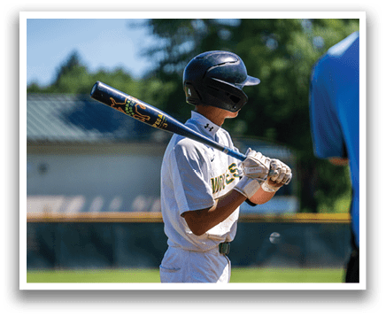 A boy holding a baseball bat. Description generated by AI
