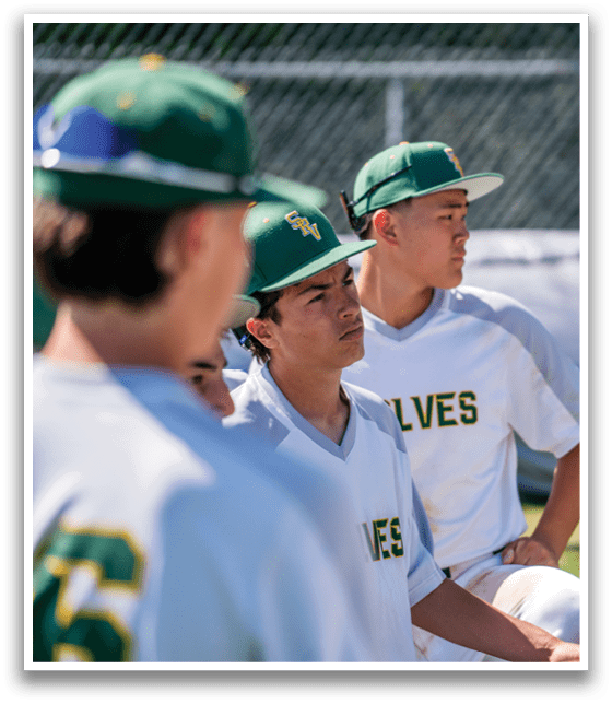 A group of baseball players wearing green and white uniforms. Description generated by AI