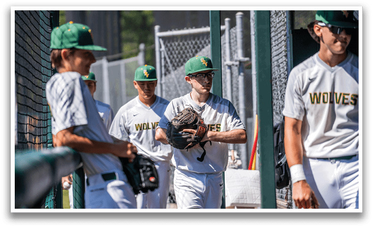 A group of baseball players wearing white uniforms. Description generated by AI