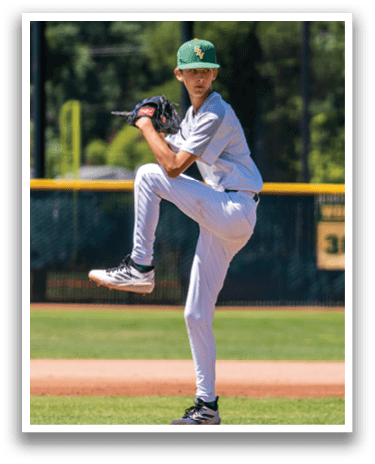 A baseball player in a green hat and white uniform is pitching a ball. Description generated by AI