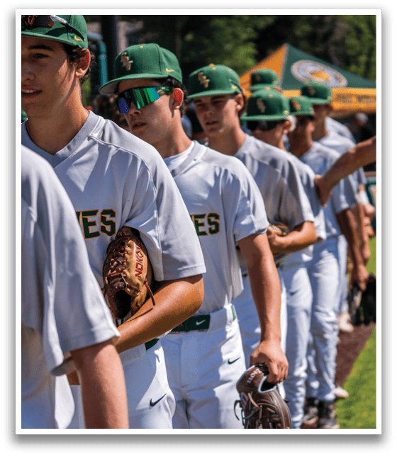A group of baseball players wearing white uniforms. Description generated by AI