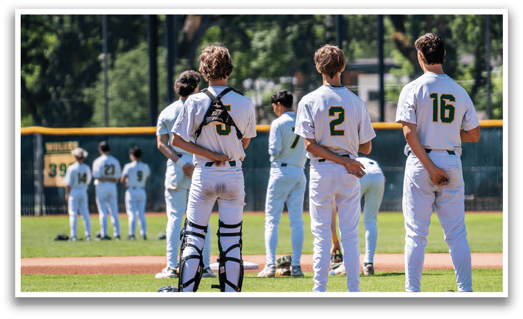 A group of baseball players standing on a field. Description generated by AI