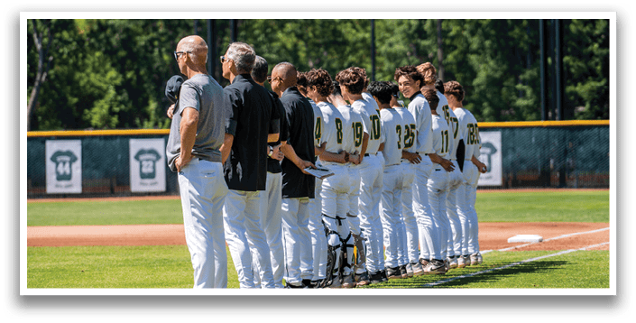 A group of baseball players standing on a field. Description generated by AI