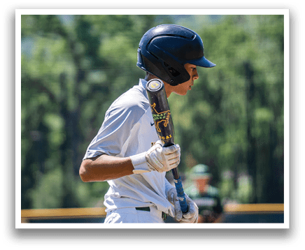 A boy holding a baseball bat. Description generated by AI