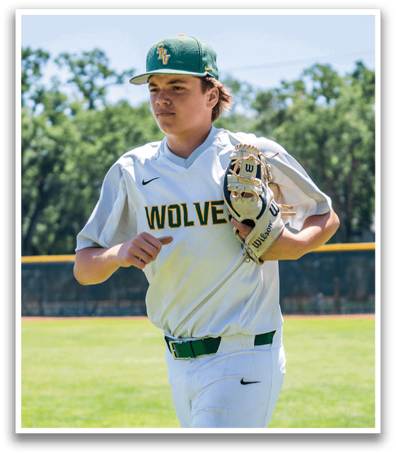 A baseball player wearing a white shirt with the word wolverine on it. Description generated by AI