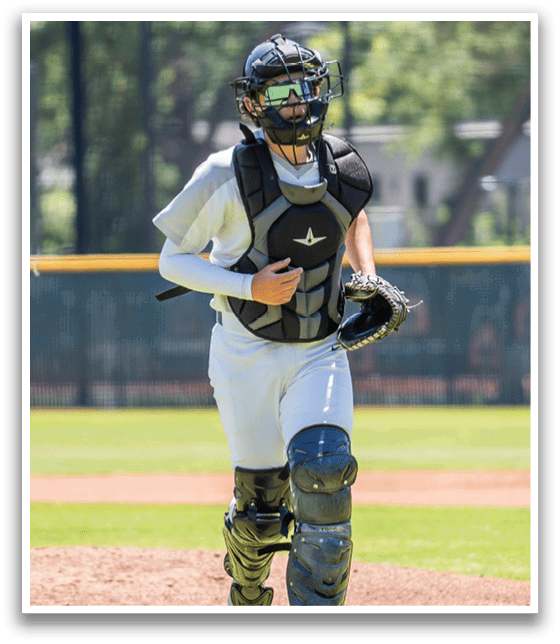 A baseball player wearing a helmet and chest protector. Description generated by AI
