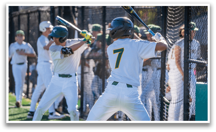 A baseball player in a white uniform is swinging a bat at a ball. AI generated content