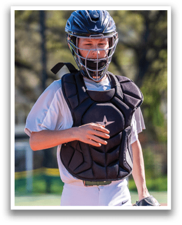 A young man wearing a baseball helmet and chest protector is holding a baseball glove. AI generated content