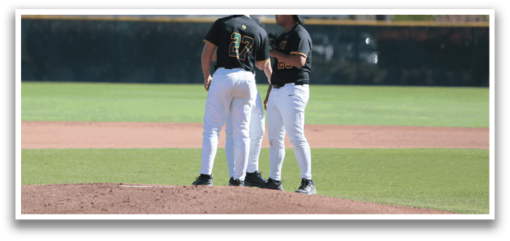 Two baseball players wearing white pants and black shirts are standing on a baseball field. AI generated content