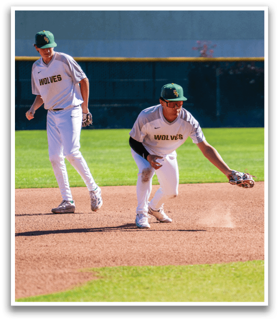 Two baseball players on a field, one wearing a white shirt and the other wearing a gray shirt. The player in the gray shirt is reaching for a ball. AI generated content