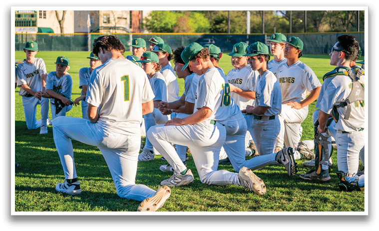 A group of baseball players kneeling on the grass, praying before a game. AI generated content