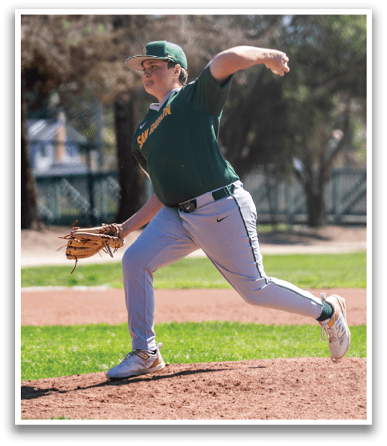 A baseball player in a green shirt and grey pants is pitching a ball. AI generated content
